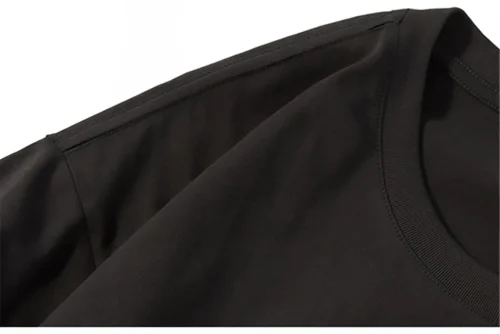 Close-up of black Bad Bunny T-shirt collar and shoulder seam detail
