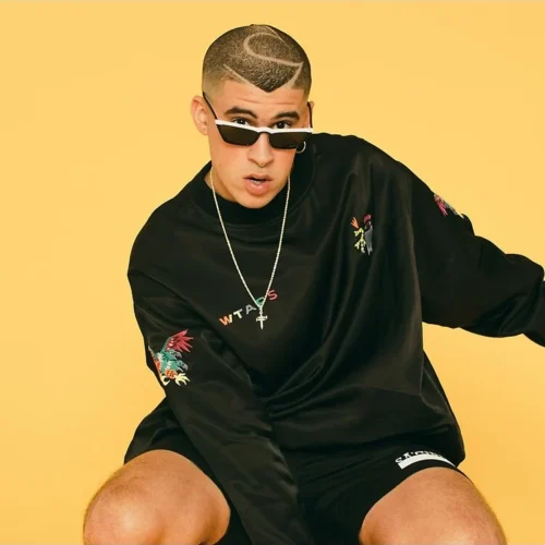 Bad Bunny seated in sunglasses on a yellow background, floor pillow photo print